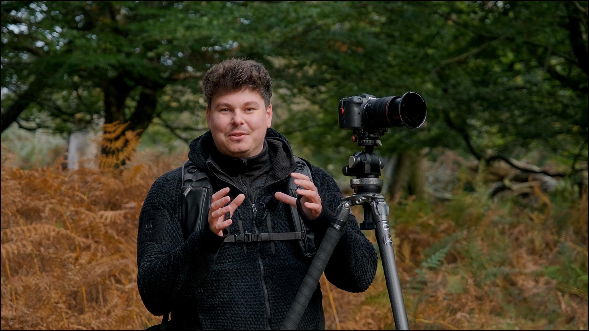 Jack lodge photographer with camera in forest