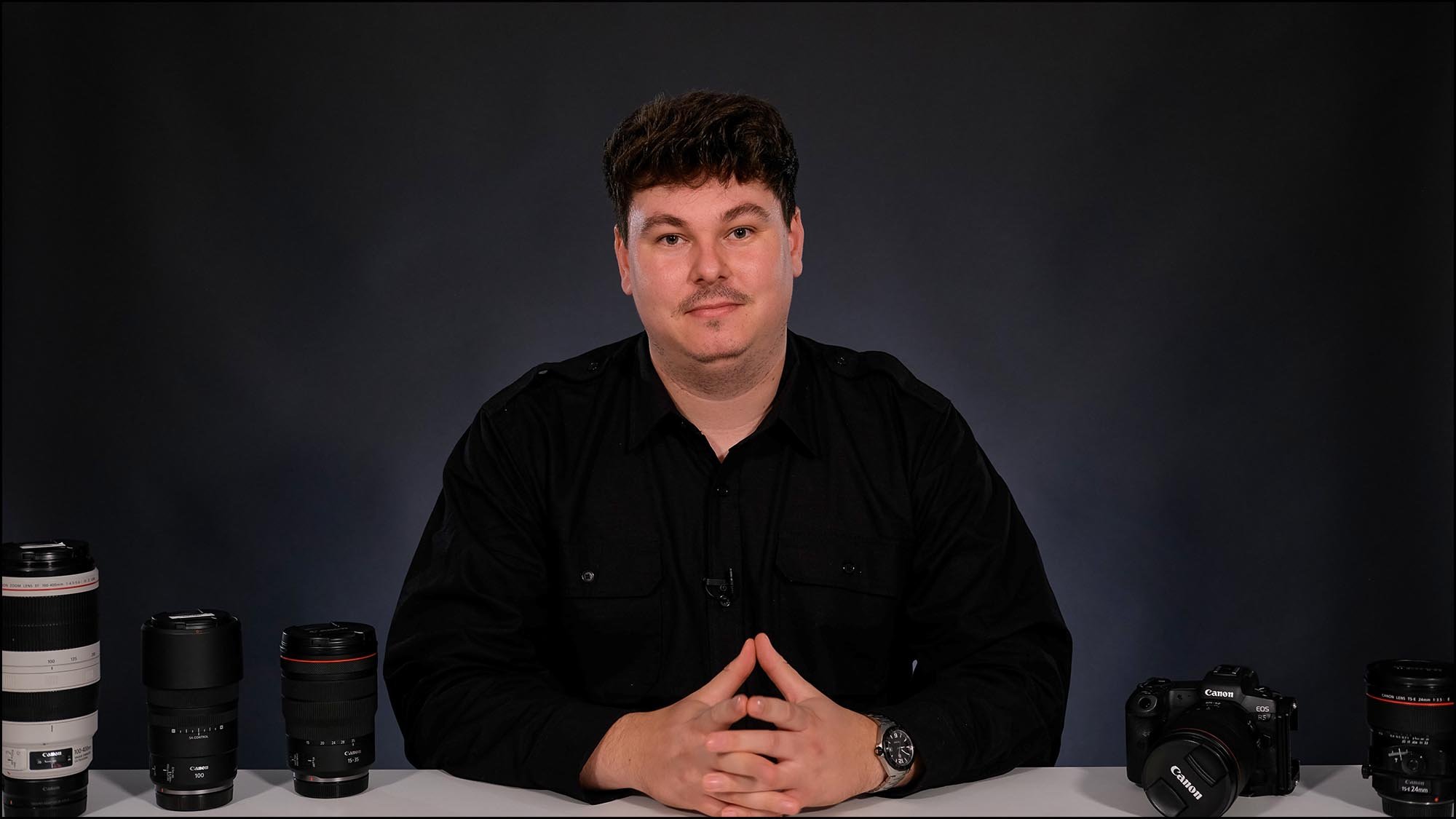 Jack Lodge Photographer at a desk with cameras and lenses