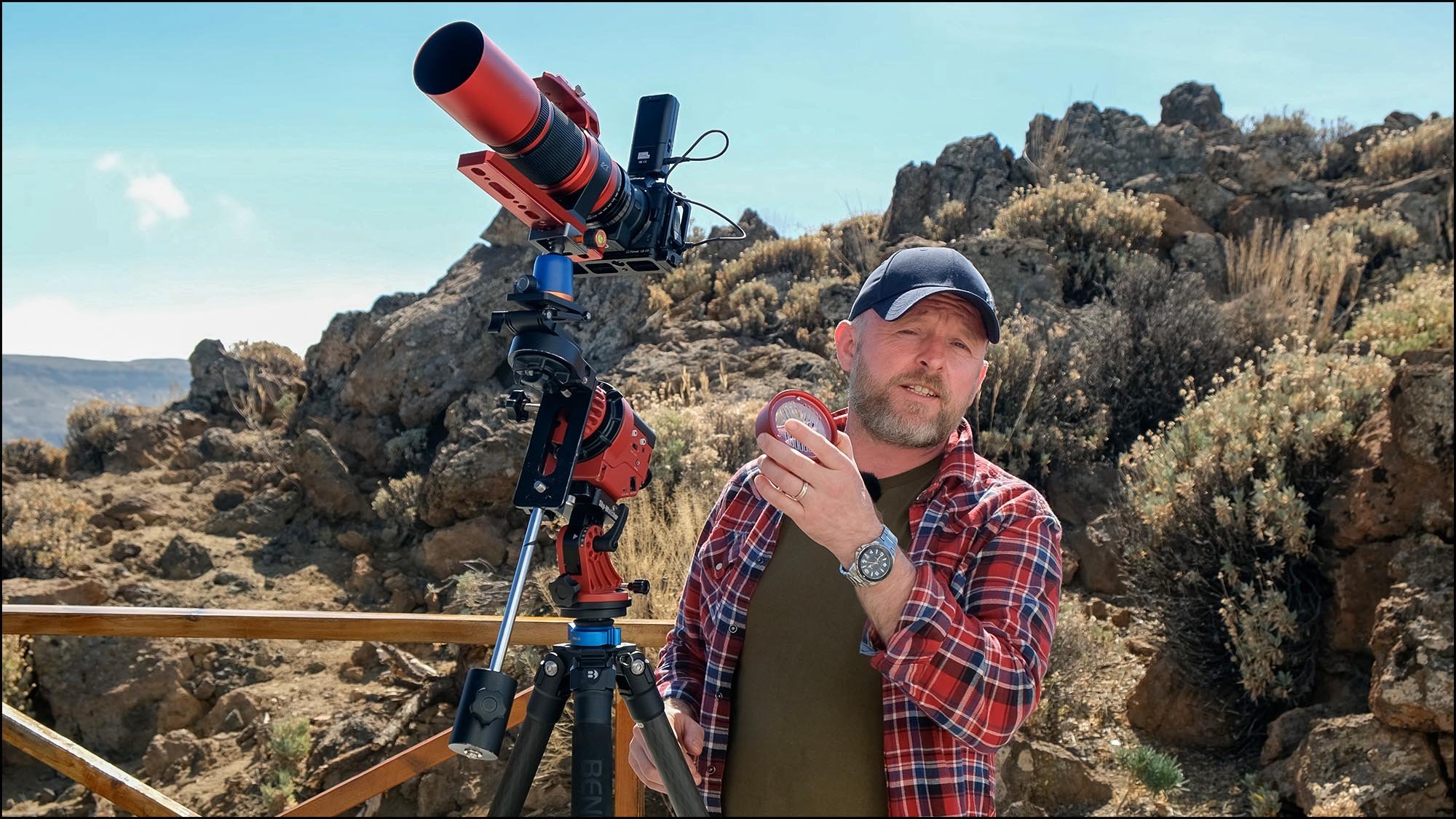 Man with astrophotography equipment on mountain