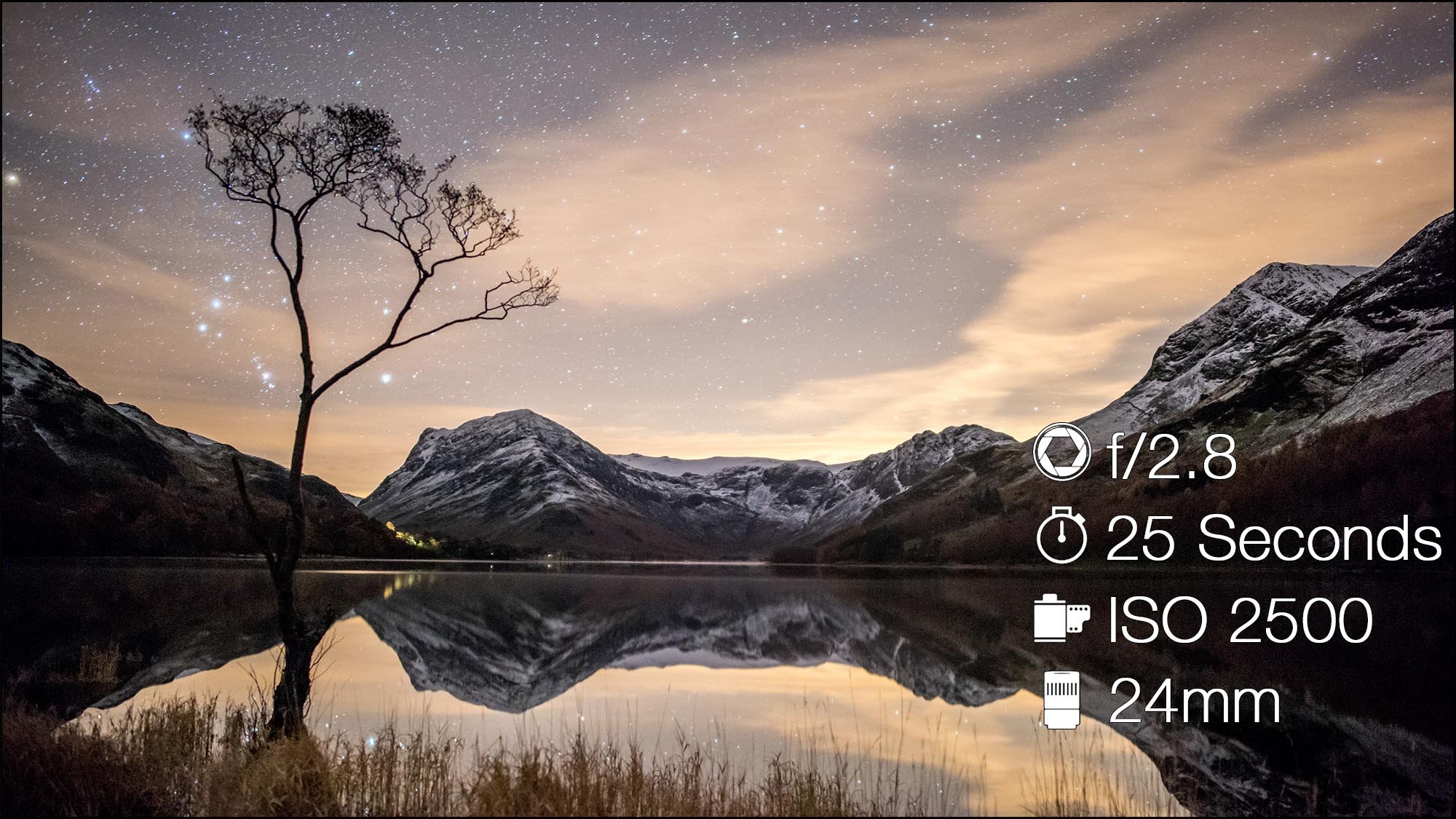 Astro photograph of mountains and lake with camera settings