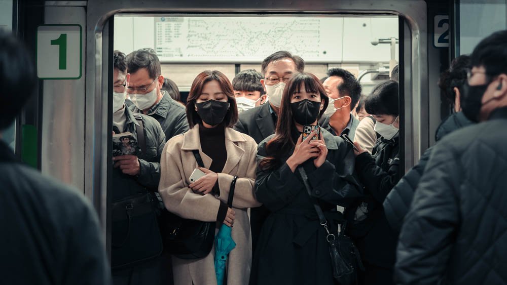 People on a crowded subway train in Asia.