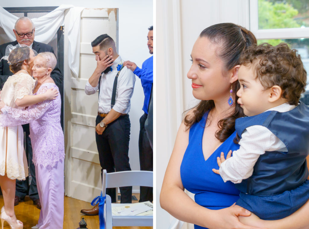 Groom wiping away a tear as mom and bride hug. On the right, sister-in-law with a tear on her cheak holding her son.